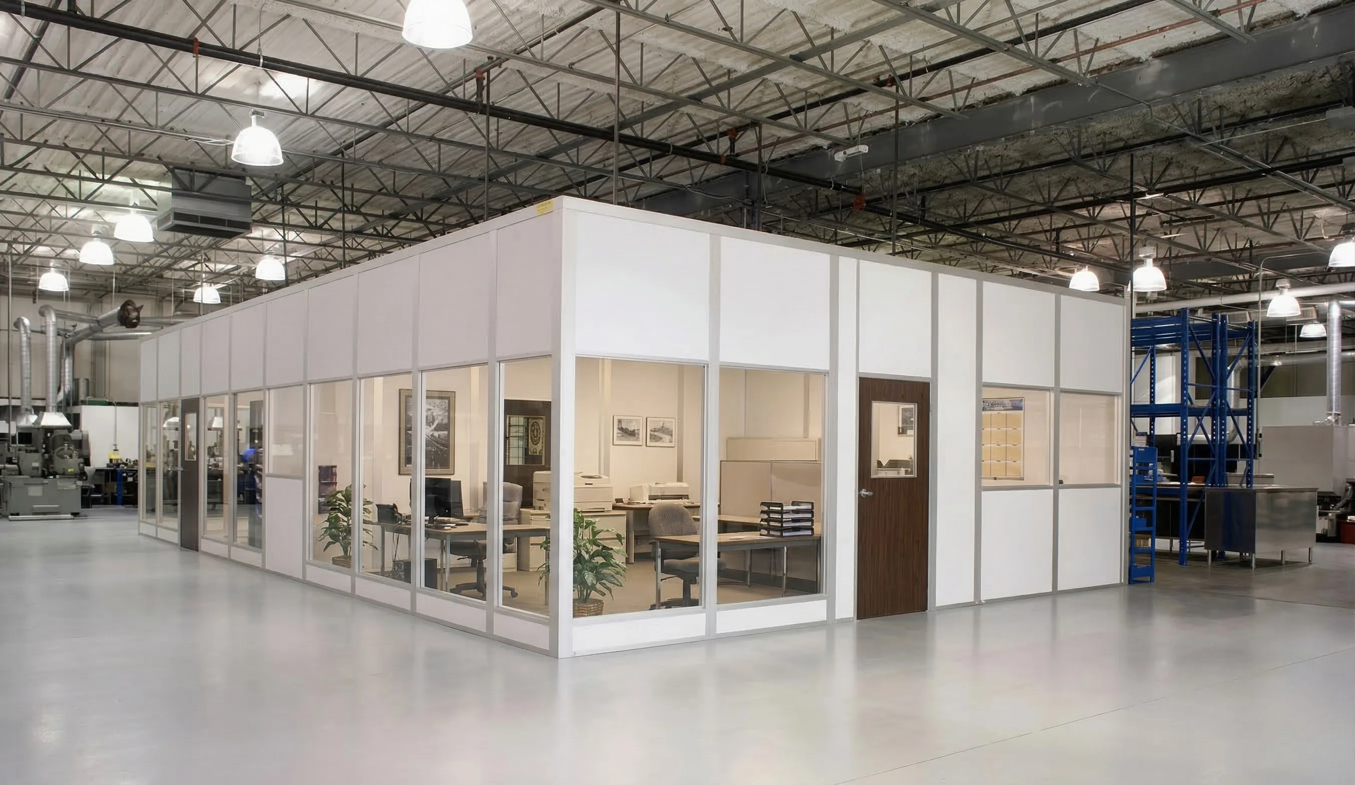 Modular office with glass walls installed inside warehouse